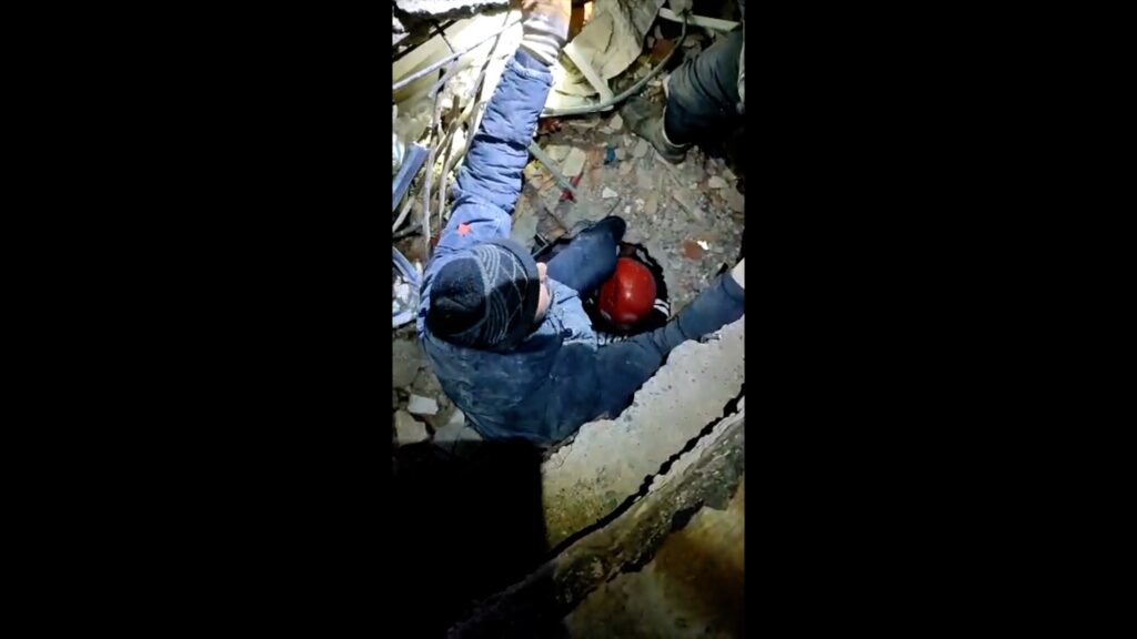 A young Turkish girl being pulled out from under the rubble of fallen buildings from the recent earthquake in Gaziantepe