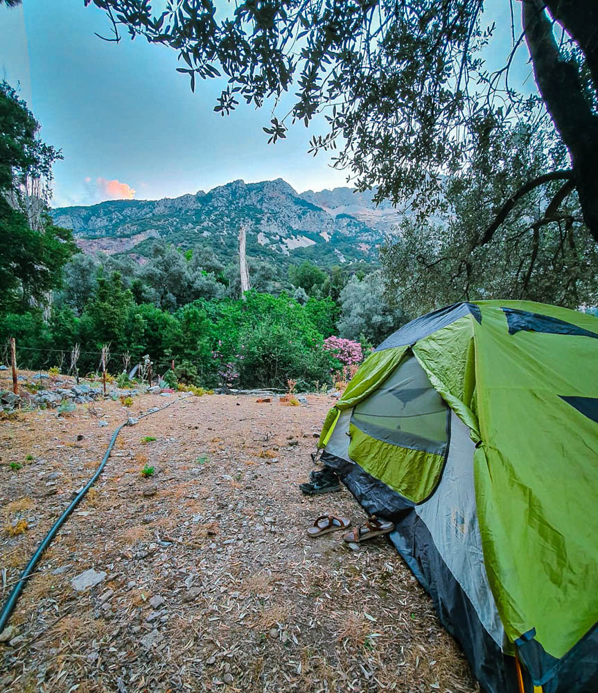 A backpacking tent beneath the mountains in Fethiye, Turkey. 